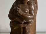 a chocolate figurine of a man holding a baby