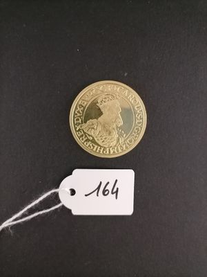 an image of a gold coin with a price tag attached to it