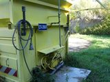 a yellow dump truck that is parked in the grass