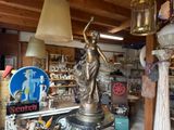 a statue of a woman holding a lamp in a shop