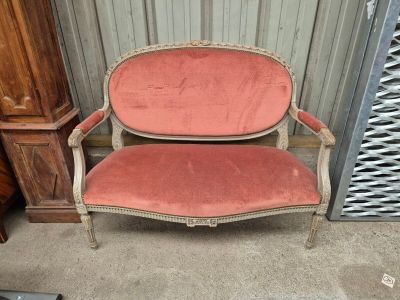 a pink chair that is sitting in front of a door