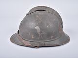 an old helmet is sitting on a white surface with a white background