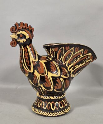a ceramic bird that is sitting on a table