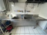 a large stainless steel sink in the middle of a kitchen