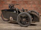 a motorcycle with a side car parked in front of a brick wall