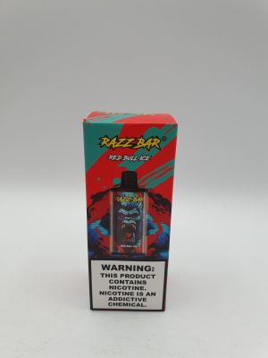 une boîte de vapeur rouge et noire posée sur une table blanche