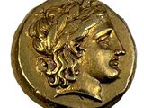 gros plan d'une pièce d'or portant un visage de femme