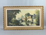 an oil painting of a house by a river in a gold frame