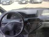 steering wheel and dashboard of a car in a parking lot
