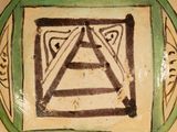 a green and white plate with a design on it