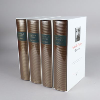 three books in a white box on a gray surface