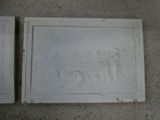 two reliefs of a man and a woman on a wall
