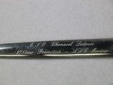 a close up of a knife with writing on it on a table
