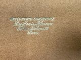 a close up of the back of a brown jacket with writing on it