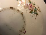 a white plate with flowers on it on a table