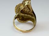 an image of a gold ring with a flower design on it