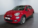 the red fiat suv is parked in a large room