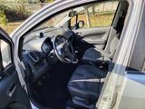 the interior of a car with the door open and the driver ' s seat down