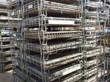 a large pile of metal scaffolding in the middle of a parking lot
