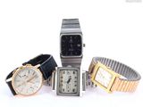 three watches are sitting next to each other on a white surface
