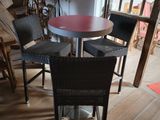 a table and chairs in a room with wood flooring