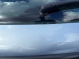 a close up of a car ' s windshield with a reflection of clouds in the windshield