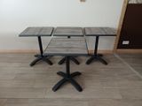 three tables and two stools in a room