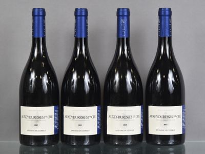 three bottles of wine are lined up on a table