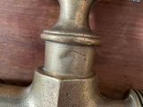 a faucet that is sitting on a wooden table