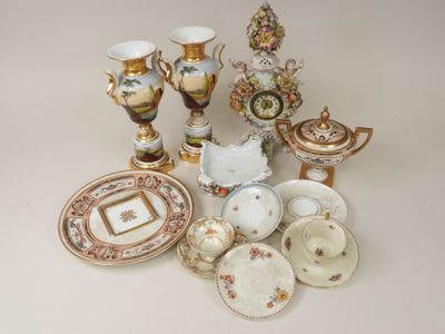 many different types of porcelain dishes and vases on the table