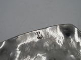 a close up of a silver plate with a number on it