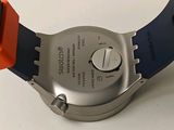 a close up of a watch on a white surface