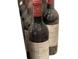 several bottles of wine are lined up in a row on a white background
