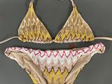 a close up of a bikini top with a tie around the bottom
