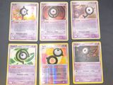 several pokemon cards sitting on top of a table next to each other