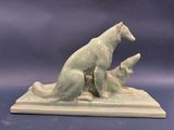a figurine of a dog and a cat sitting on a table