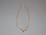 gold plated necklace with a heart shaped pendant on a gold chain