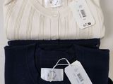 three pairs of sweaters are stacked on top of each other