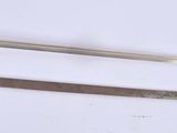 two swords that are laying on a white surface