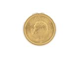 a close up of a gold coin on a white surface