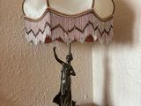 a lamp that is sitting on a table with a lamp shade on it