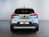 the rear end of a silver car in a white room