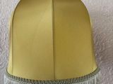 a lamp that has a yellow shade on it