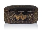 a black and gold box sitting on a white surface