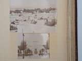an old photo of an open book with a picture of a town