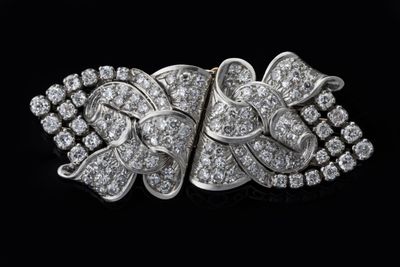 a close up of a diamond broochle on a black background