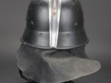 an old helmet is sitting on top of a metal stand