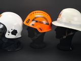 three different types of hard hats on display on a black background