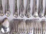 a lot of silver spoons and forks on the table