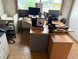 a desk with two computer monitors and a printer on it